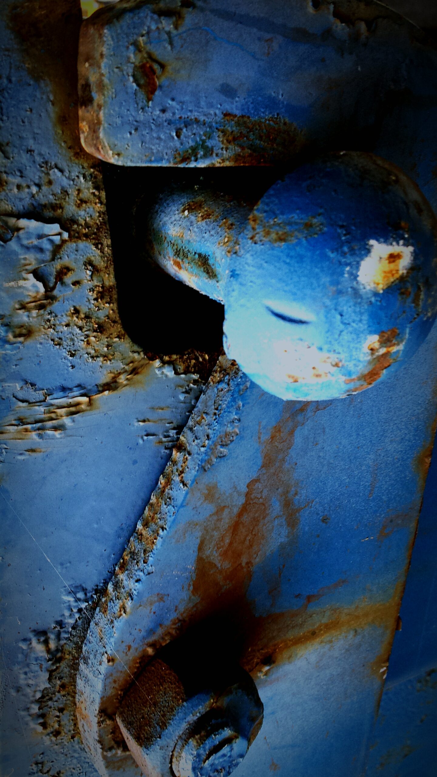 close-up-rusty-metallic-blue-hinge-lock Excavator bucket dropping dirt into an open trench.