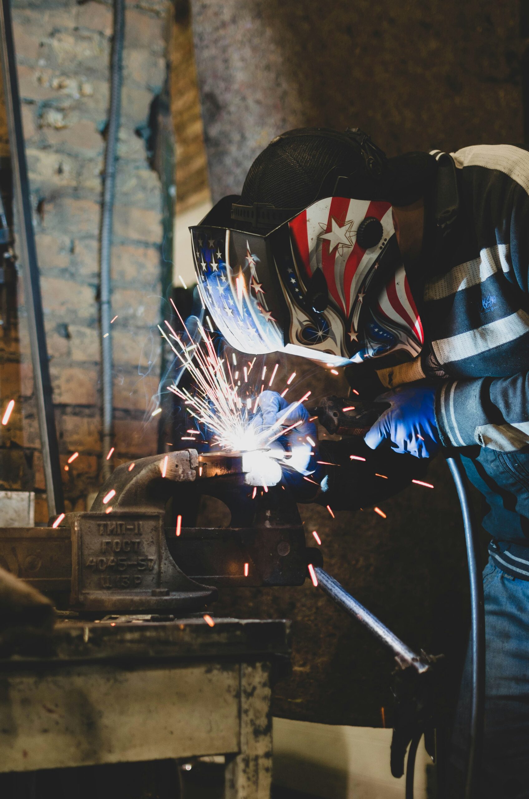 Excavator bucket dropping dirt into an open trench.
