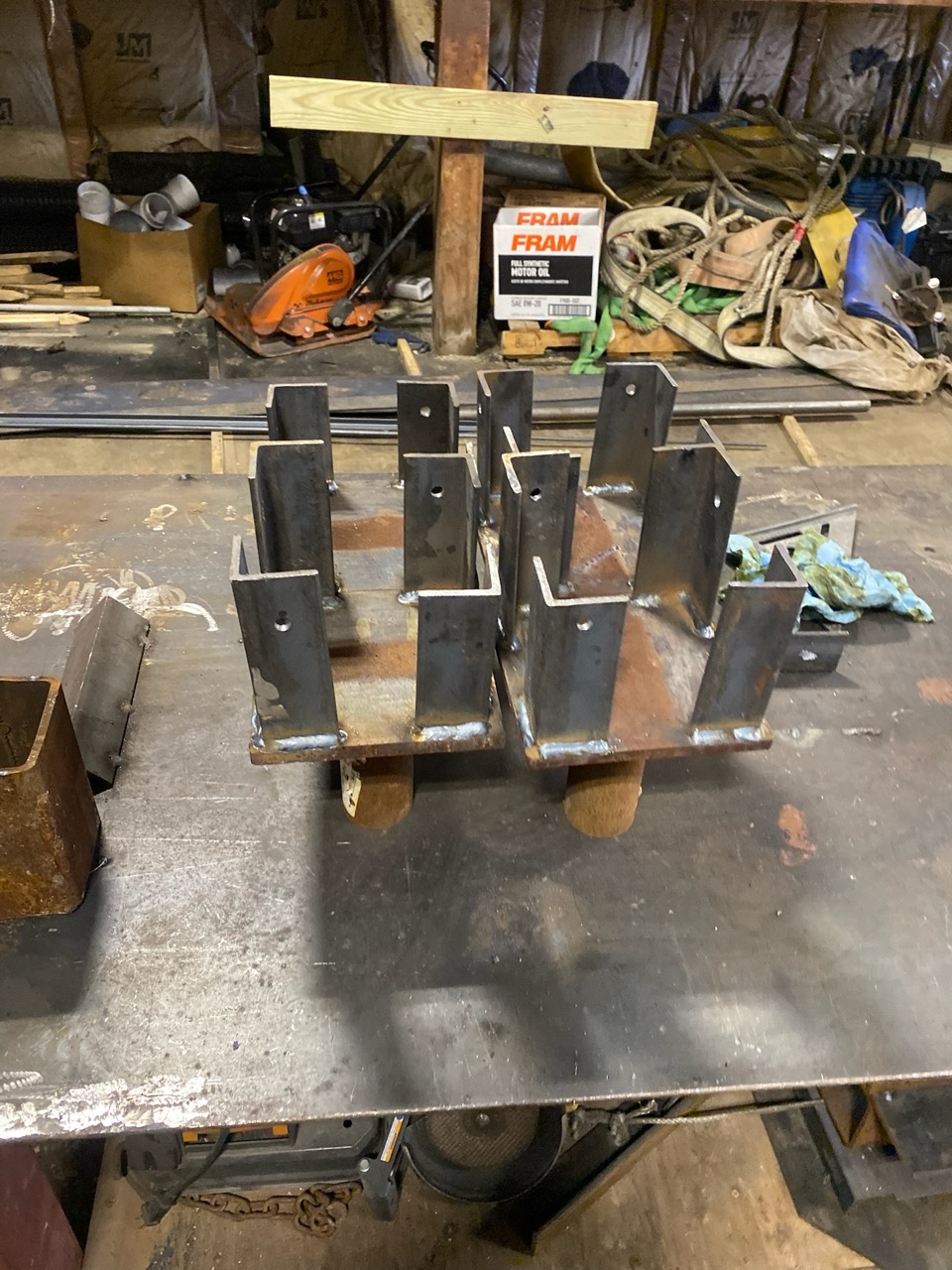 Excavator bucket dropping dirt into an open trench.