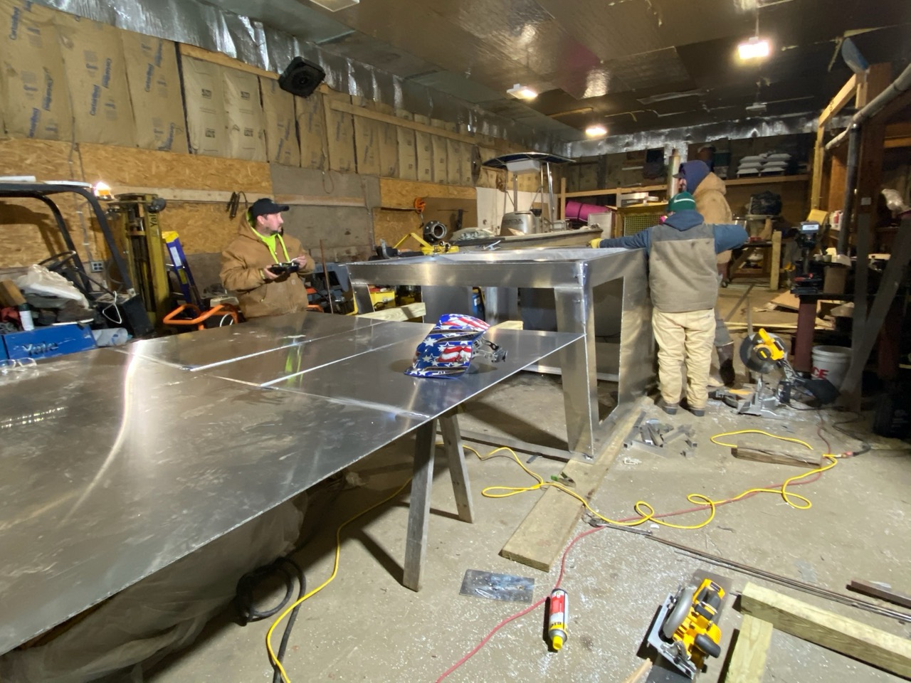 workshop Excavator bucket dropping dirt into an open trench.